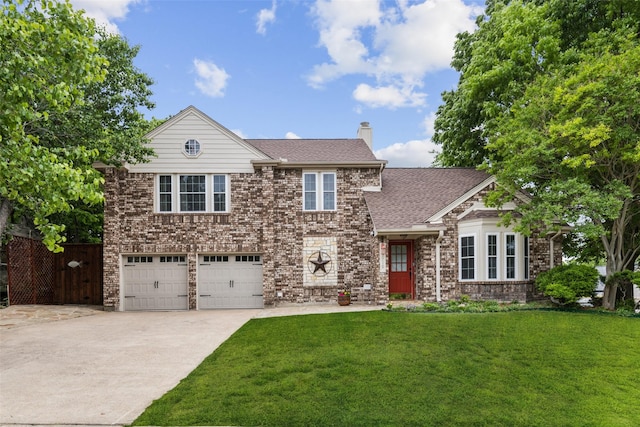 view of front of property with an attached garage, a chimney, driveway, and a front yard