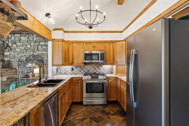 kitchen with backsplash, appliances with stainless steel finishes, a sink, light stone counters, and an inviting chandelier
