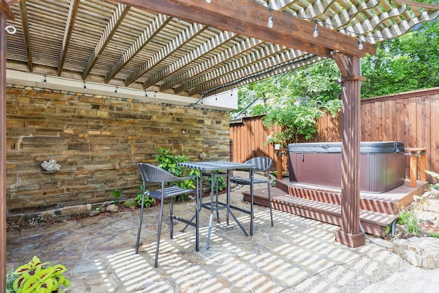 view of patio / terrace with fence, a pergola, outdoor dining area, and a hot tub
