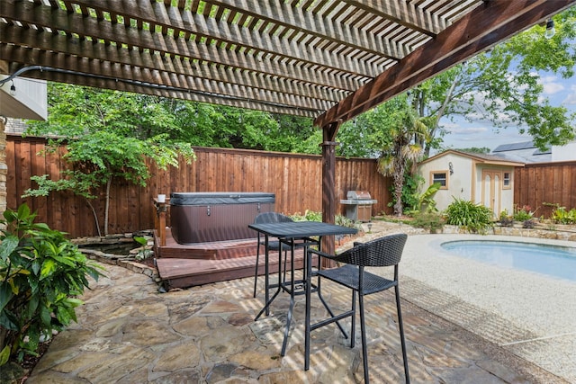 view of patio with a fenced backyard, a fenced in pool, a hot tub, an outbuilding, and outdoor dining space