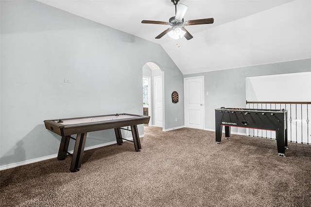 game room featuring a ceiling fan, arched walkways, vaulted ceiling, baseboards, and carpet