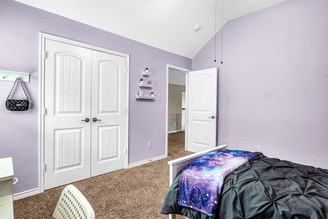 bedroom featuring carpet floors, baseboards, a closet, and lofted ceiling