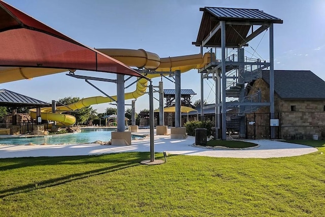 view of property's community featuring a lawn, a swimming pool, stairs, and fence