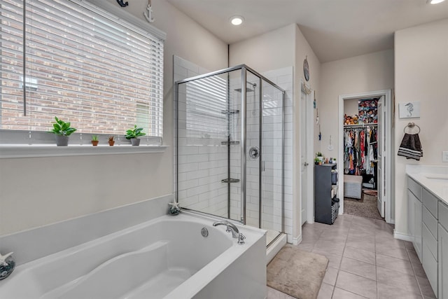 2561 Pettus Dr, Forney, TX 75126 - full bath with tile patterned floors, a shower stall, a walk in closet, and a bath