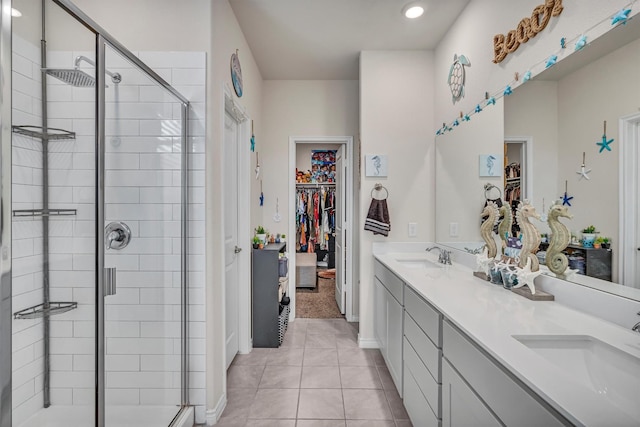 2561 Pettus Dr, Forney, TX 75126 - full bathroom with tile patterned flooring, double vanity, a walk in closet, a shower stall, and a sink