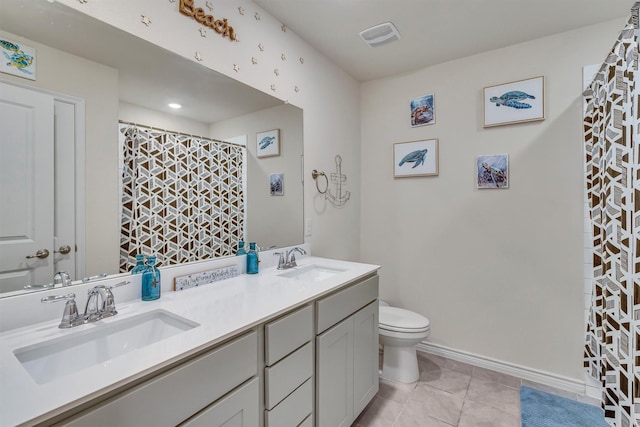 2561 Pettus Dr, Forney, TX 75126 - bathroom featuring double vanity, toilet, a sink, and tile patterned flooring