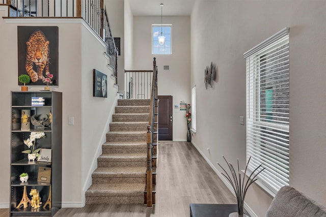 2561 Pettus Dr, Forney, TX 75126 - entrance foyer featuring visible vents, a towering ceiling, wood finished floors, stairway, and baseboards