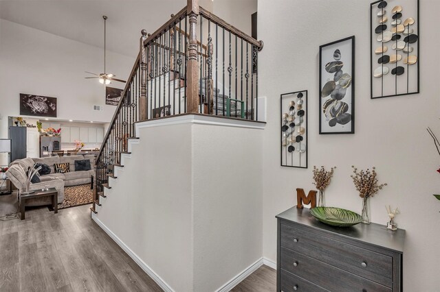 2561 Pettus Dr, Forney, TX 75126 - staircase with a ceiling fan, baseboards, wood finished floors, and a towering ceiling