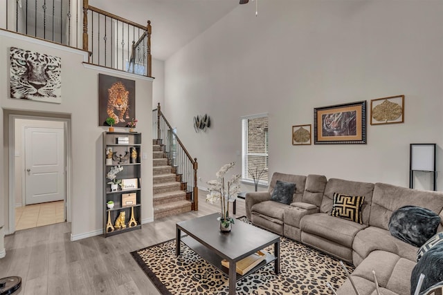 2561 Pettus Dr, Forney, TX 75126 - living room with high vaulted ceiling, stairs, a ceiling fan, baseboards, and light wood-type flooring