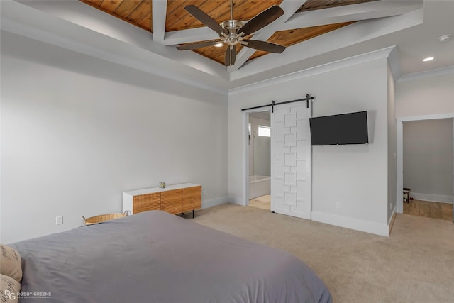 bedroom with carpet floors, baseboards, and a barn door