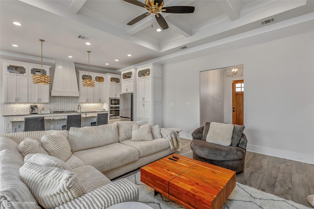living room featuring ceiling fan, visible vents, wood finished floors, beamed ceiling, and recessed lighting