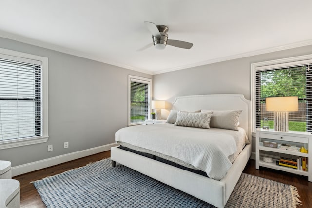 bedroom with baseboards, ornamental molding, a ceiling fan, and wood finished floors