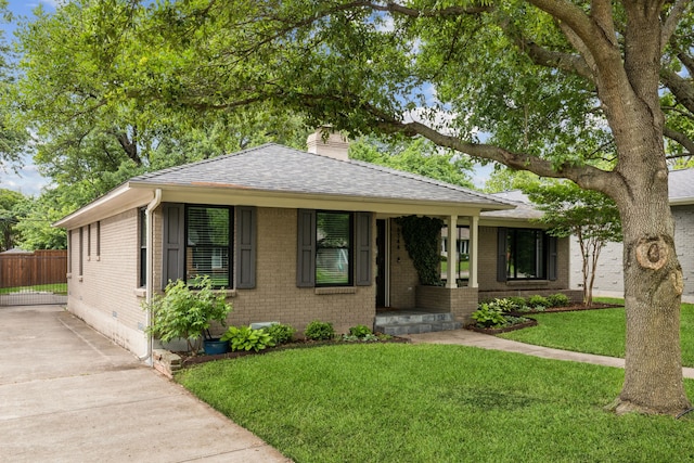 view of front of property featuring crawl space, a chimney, a front yard, brick siding, and a shingled roof