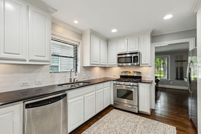 kitchen featuring ornamental molding, white cabinetry, and stainless steel appliances