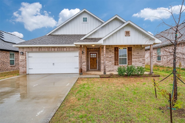 view of front of property featuring board and batten siding, driveway, a front yard, brick siding, and an attached garage