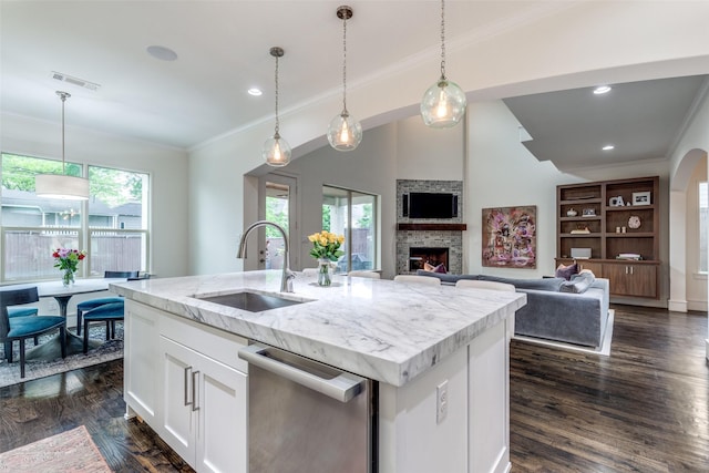 kitchen with crown molding, a sink, dishwasher, and a healthy amount of sunlight