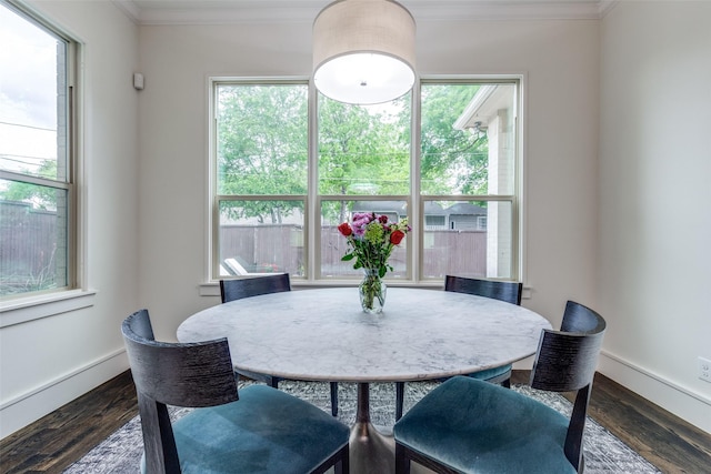 dining area featuring plenty of natural light, baseboards, ornamental molding, and dark wood-style flooring