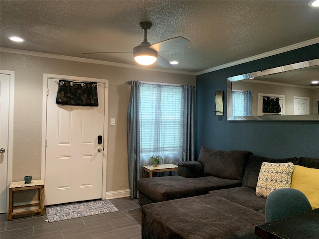 living area with crown molding, baseboards, recessed lighting, a textured ceiling, and a ceiling fan