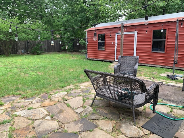 view of yard featuring an outdoor structure, fence private yard, and a patio area