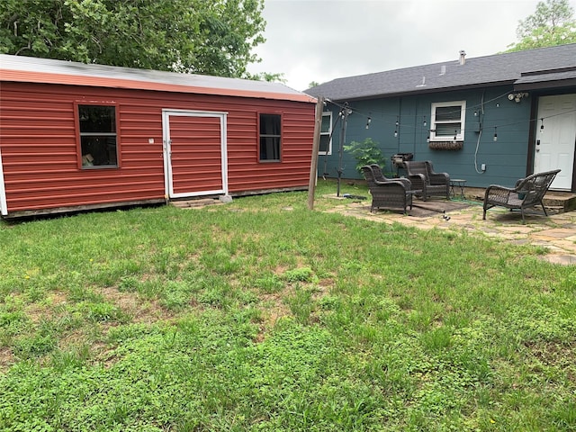 view of yard with an outbuilding and a patio area