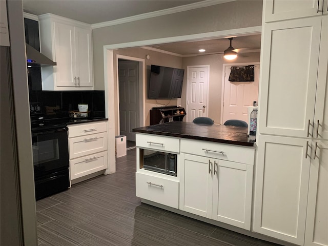 kitchen featuring white cabinets, backsplash, dark countertops, and black appliances
