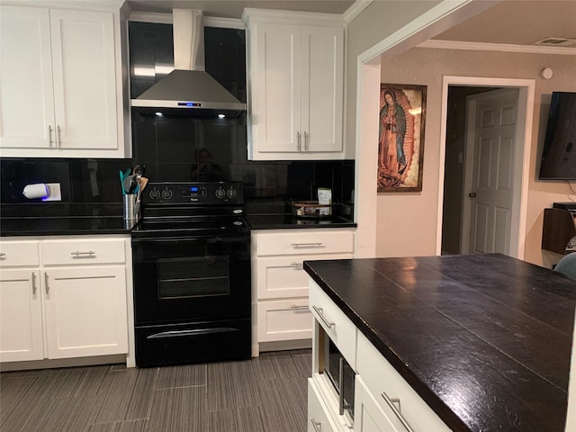 kitchen with wall chimney range hood, dark countertops, black electric range oven, and tasteful backsplash