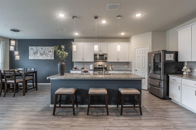 600 Goldenrod Ln, Princeton, TX 75407 - kitchen featuring white cabinetry, appliances with stainless steel finishes, a sink, and tasteful backsplash
