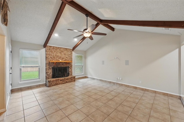 unfurnished living room featuring a ceiling fan, a textured ceiling, lofted ceiling with beams, and light tile patterned flooring