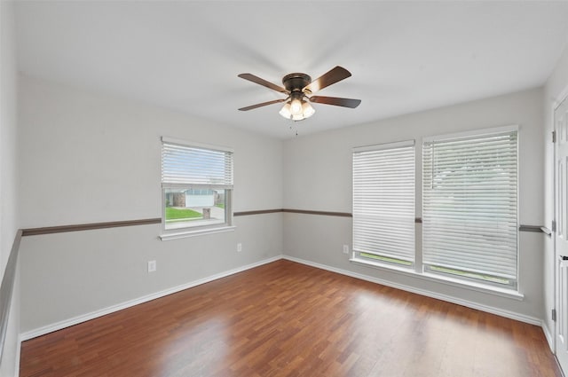 empty room with baseboards, ceiling fan, and wood finished floors