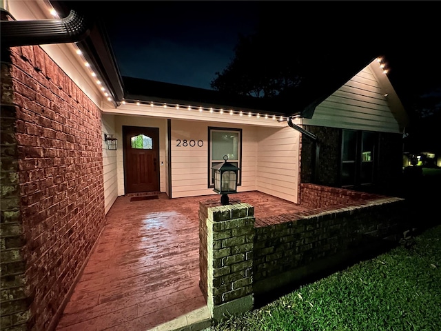 view of exterior entry at night