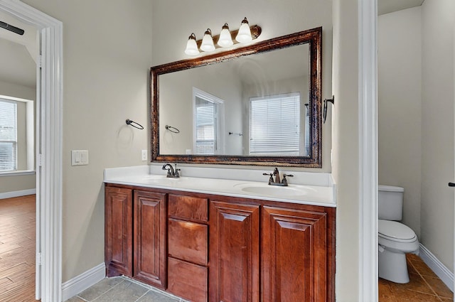 5012 Spruce St, Krum, TX 76249 - kitchen featuring light stone countertops, appliances with stainless steel finishes, a sink, arched walkways, and tasteful backsplash