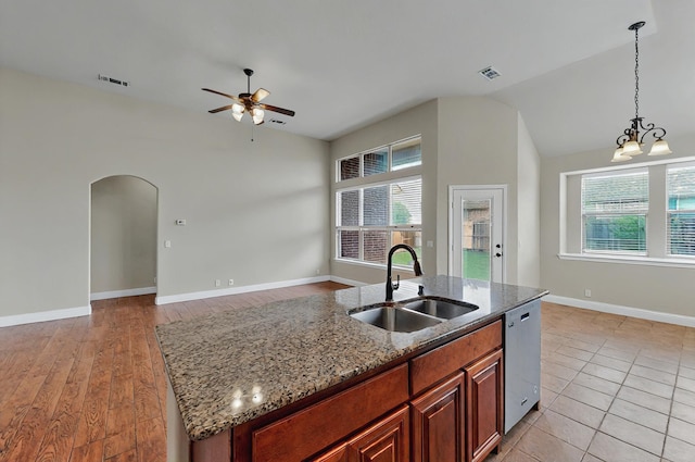 kitchen with visible vents, a healthy amount of sunlight, a sink, and ceiling fan with notable chandelier