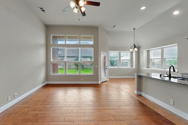 5012 Spruce St, Krum, TX 76249 - unfurnished bedroom with visible vents, multiple windows, and wood finished floors
