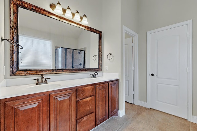 bathroom with a sink, tile patterned flooring, double vanity, baseboards, and a stall shower