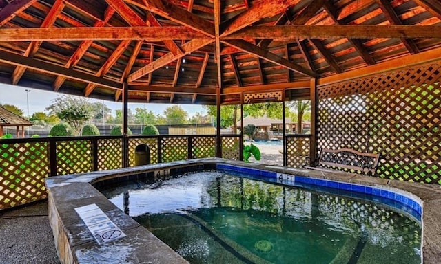 view of pool featuring a gazebo, fence, and a pool
