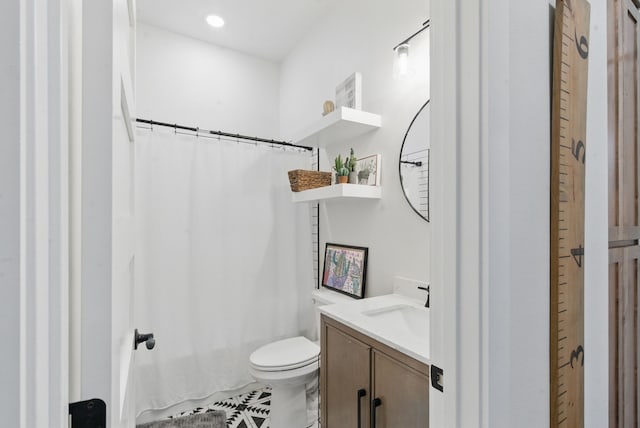 full bathroom featuring vanity, tile patterned floors, and toilet