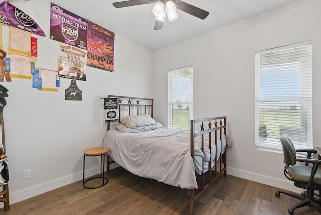 bedroom with baseboards, ceiling fan, and wood finished floors