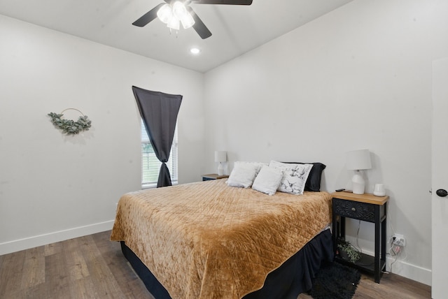 bedroom featuring baseboards, ceiling fan, and wood finished floors