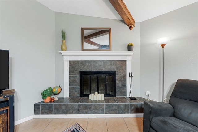 tiled living area featuring a tiled fireplace and beamed ceiling