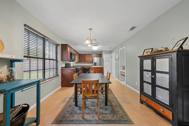dining room featuring visible vents, baseboards, light tile patterned floors, and a chandelier