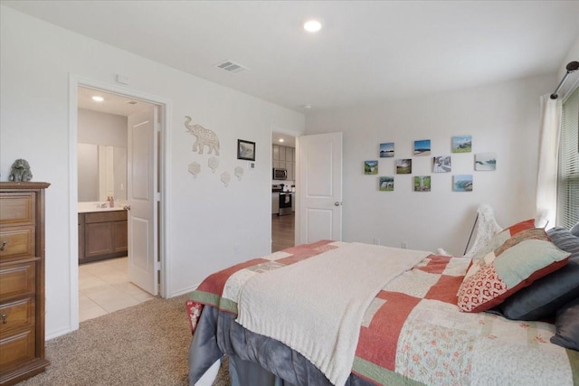 bedroom with visible vents, recessed lighting, light tile patterned floors, and light carpet