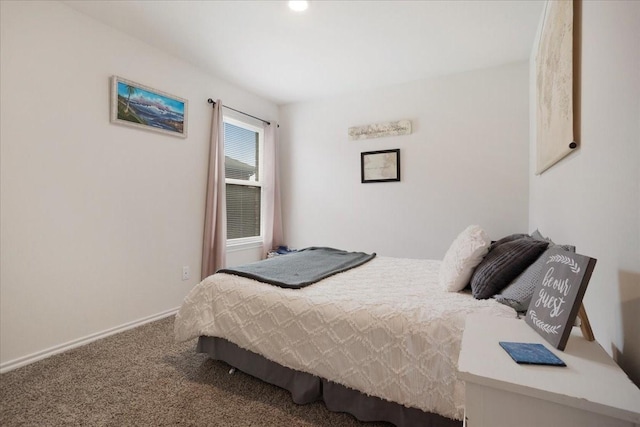 bedroom featuring baseboards and carpet