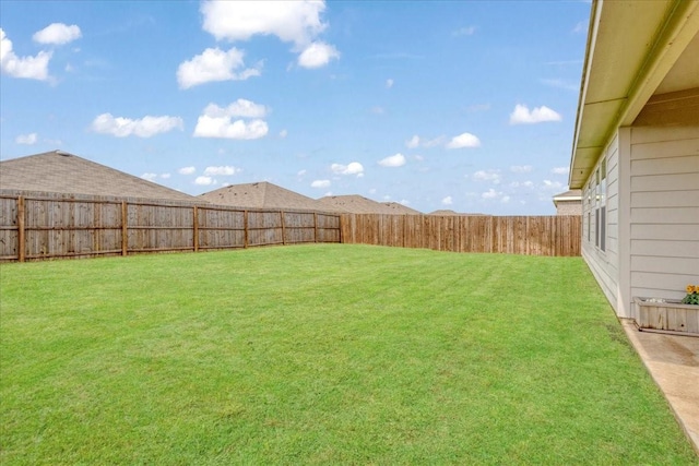 view of yard with a fenced backyard