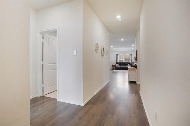 corridor with baseboards, recessed lighting, and wood finished floors