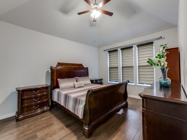 bedroom featuring a ceiling fan, baseboards, dark wood finished floors, and vaulted ceiling