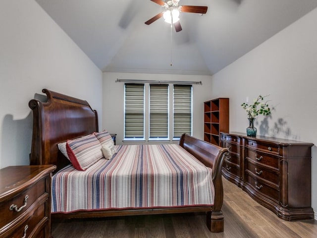 bedroom with a ceiling fan, wood finished floors, and lofted ceiling