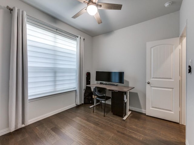 office space featuring a ceiling fan, baseboards, and wood finished floors