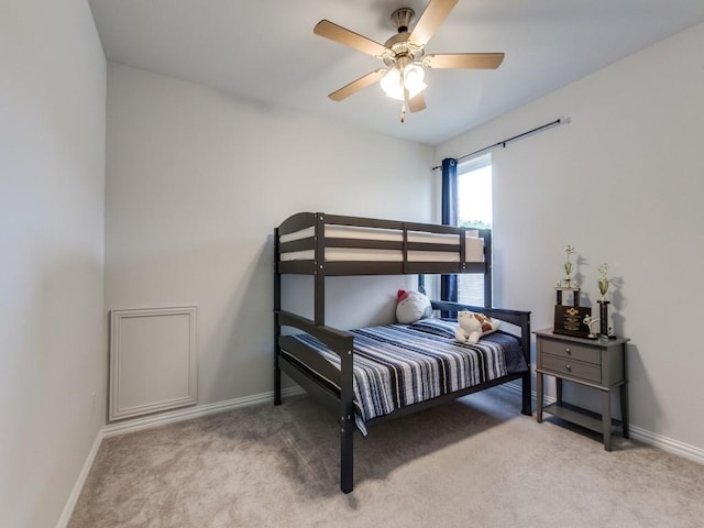 carpeted bedroom featuring baseboards and ceiling fan