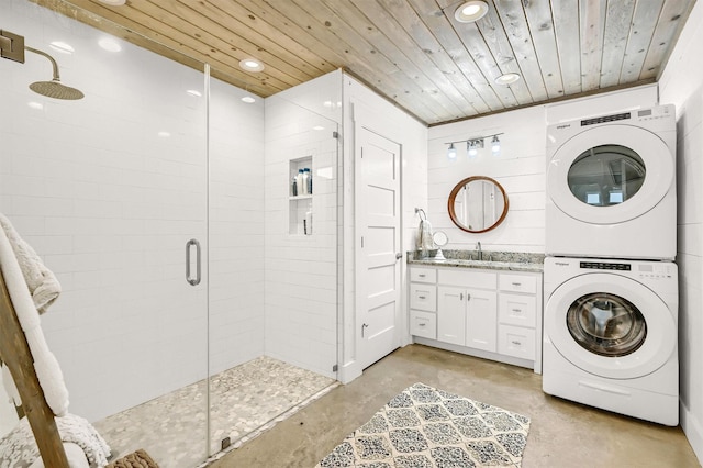 clothes washing area with laundry area, recessed lighting, stacked washing maching and dryer, and wooden ceiling