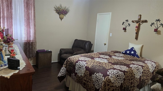bedroom with dark wood-type flooring